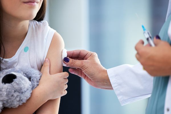 Shot of a little girl getting a vaccination in a clinic.